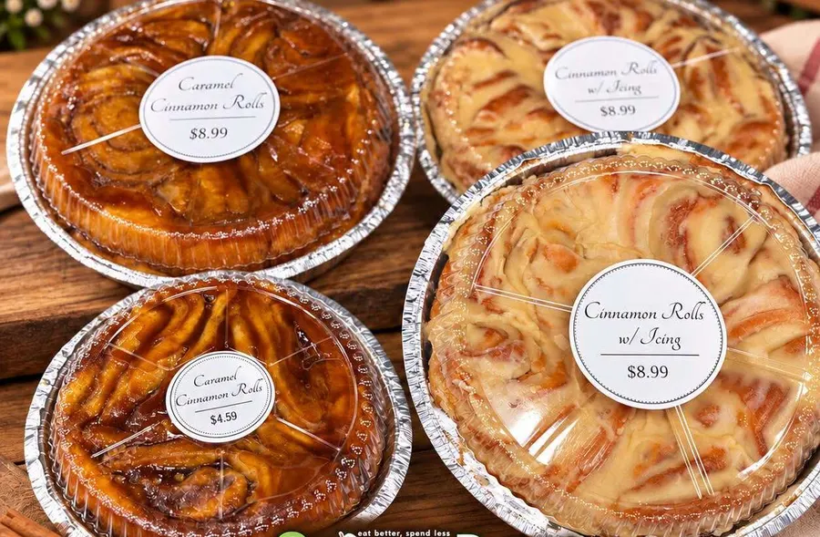 Pans of caramel cinnamon rolls and iced cinnamon rolls with price labels